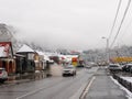 Chemal, Altai Republic, Russia - 15 October 2020: Russian rural village Chemal in the snow. Cars drive along the main road along