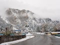 Chemal, Altai Republic, Russia - 15 October 2020: Russian rural village Chemal in the snow. The main road against the background