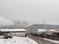 Chemal, Altai Republic, Russia - 15 October 2020: Russian rural village Chemal in the snow. Village street. Altai mountains are