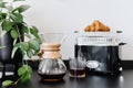 Chemex with black filtered coffee and glass on table indoors Royalty Free Stock Photo