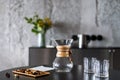 Chemex for brewing coffee and glass on dark table Royalty Free Stock Photo