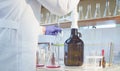 Chemical analysis laboratory. Hands of a scientist titrating solution Royalty Free Stock Photo