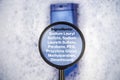 Chemical components on the shampoo label: Sodium Lauryl Sulfate sls, sles. A hand holds a blue jar and a magnifier, where the