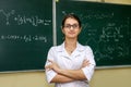 Chemical education. Woman near board explaining to students some material