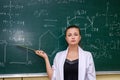 Chemical education. Woman near board explaining to students some material