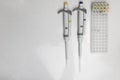 Chemical equipment are on the white background. Automatic pipettes and microtube rack on the working surface in the scientific.