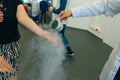 Chemical event at the birthday party: children's hands touch the smoke from liquid nitrogen