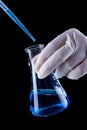 Chemical experiment concept with blue liquid filling Erlenmeyer Royalty Free Stock Photo