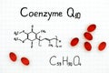 Chemical formula of Coenzyme Q10 with red pills.