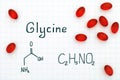 Chemical formula of Glycine with red pills Royalty Free Stock Photo