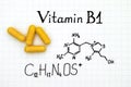 Chemical formula of Vitamin B1 and yellow pills. Royalty Free Stock Photo