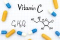 Chemical formula Vitamin C and pills. Royalty Free Stock Photo