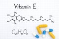 Chemical formula of Vitamin E and pills. Royalty Free Stock Photo
