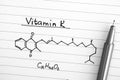 Chemical formula of Vitamin K with black pen. Royalty Free Stock Photo