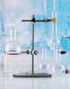 Chemical glassware with rack close-up on blue background Royalty Free Stock Photo