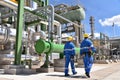 Chemical industry plant - workers in work clothes in a refinery with pipes and machinery Royalty Free Stock Photo