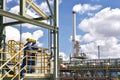 chemical industry plant - workers in work clothes in a refinery with pipes and machinery Royalty Free Stock Photo