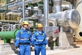 chemical industry plant - workers in work clothes in a refinery with pipes and machinery Royalty Free Stock Photo