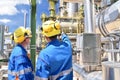 chemical industry plant - workers in work clothes in a refinery with pipes and machinery Royalty Free Stock Photo