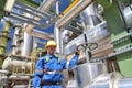 chemical industry plant - workers in work clothes in a refinery with pipes and machinery Royalty Free Stock Photo