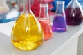 Chemical laboratory flask with blue purple-pink liquid stand on the table Royalty Free Stock Photo