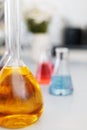 Chemical laboratory flask with blue purple-pink liquid stand on the table Royalty Free Stock Photo