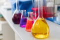 Chemical laboratory flask with blue purple-pink liquid stand on the table Royalty Free Stock Photo