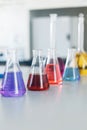 Chemical laboratory flask with blue purple-pink liquid stand on the table Royalty Free Stock Photo