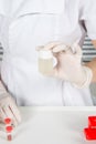 Chemical laboratory scene scientist doctor in medical gloves holding an ampula with vaccine Coronavirus covid19 epidemic medicine