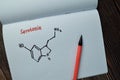 Chemical molecular Formule Hormone Serotonin write on a book isolated on Wooden Table Royalty Free Stock Photo