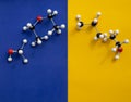 Top view of molecular atom models isolated on blue and yellow background