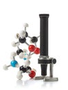 Chemical molecule model with old microscope over white background Royalty Free Stock Photo
