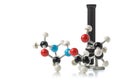 Chemical molecule model with old microscope over white background Royalty Free Stock Photo