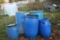 The blue plastic barrels for storage of chemicals . Stockpile of used blue plastic drums for storing water and other liquids Royalty Free Stock Photo