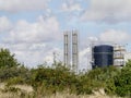 Chemical plant viewed over bushes