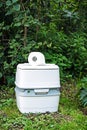 Chemical portable toilet. Single portable toilet standing on green nature courtyard background