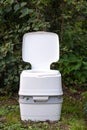 Chemical portable toilet. Single portable toilet standing on a green meadow