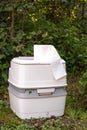 Chemical portable toilet. Single portable toilet standing on a green meadow