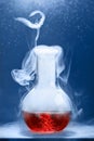 Chemical reaction in volumetric flask glass in labolatory. The concept of scientific experiments Royalty Free Stock Photo