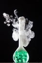 Chemical reaction in volumetric flask glass in labolatory Royalty Free Stock Photo