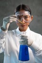 Young female chemist doing science experiment with chemicals Royalty Free Stock Photo