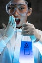 Young female chemist doing science experiment with chemicals Royalty Free Stock Photo