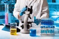 Chemical researcher working in research lab with material and microscope