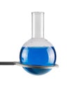 Chemical round bottom flask with blue liquid in tripod ring isolated on white