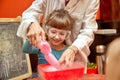 Chemical show for kids. Professor carried out chemical experiments with liquid nitrogen on Birthday little girl.