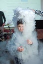 Chemical show for kids. Professor carried out chemical experiments with liquid nitrogen on Birthday little boy . The child was