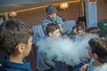 Chemical show for kids. Professor carried out chemical experiments with liquid nitrogen on Birthday little boy . The child was