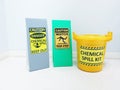 The Chemical Spill kit in yellow bucket and warning danger caution hazard tag sign or symbol for emergency response situation.