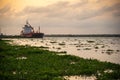 Chemical tanker docked in the Magdalena River at sunset. Colombia.