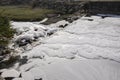 Chemical waste foams on the river. Royalty Free Stock Photo